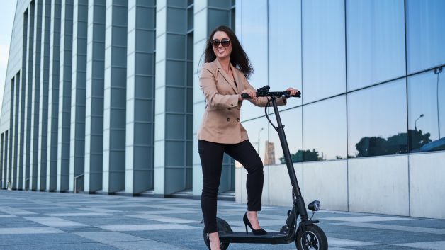 https://www.naki-naki.co.il/wp-content/uploads/2024/03/young-woman-formal-wear-glasses-is-riding-electrical-scooter-from-her-work-628x353.jpg